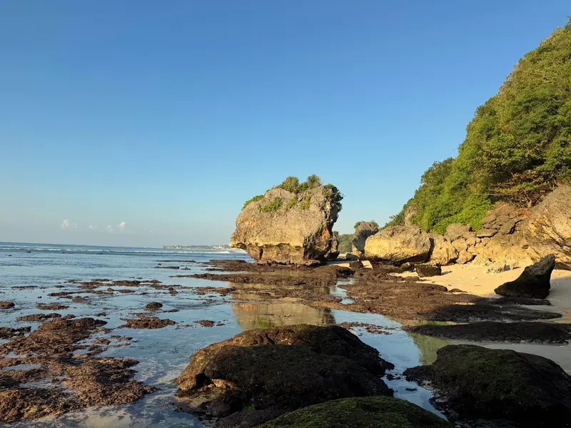 Rocky tide pools and sea stacks on the shore below the cliffs near Alila Villas Uluwatu, Bali