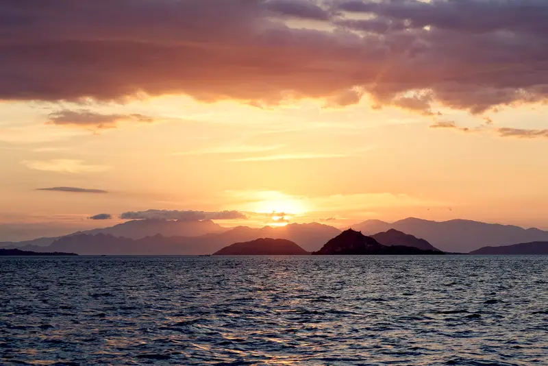 Sunset over the sea in Komodo National Park, Indonesia, on Luminara’s Bali sailings