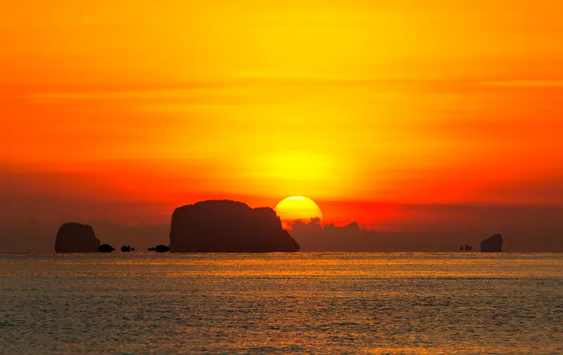 Sunset over Phang Nga Bay off Phuket, Thailand, from a yacht